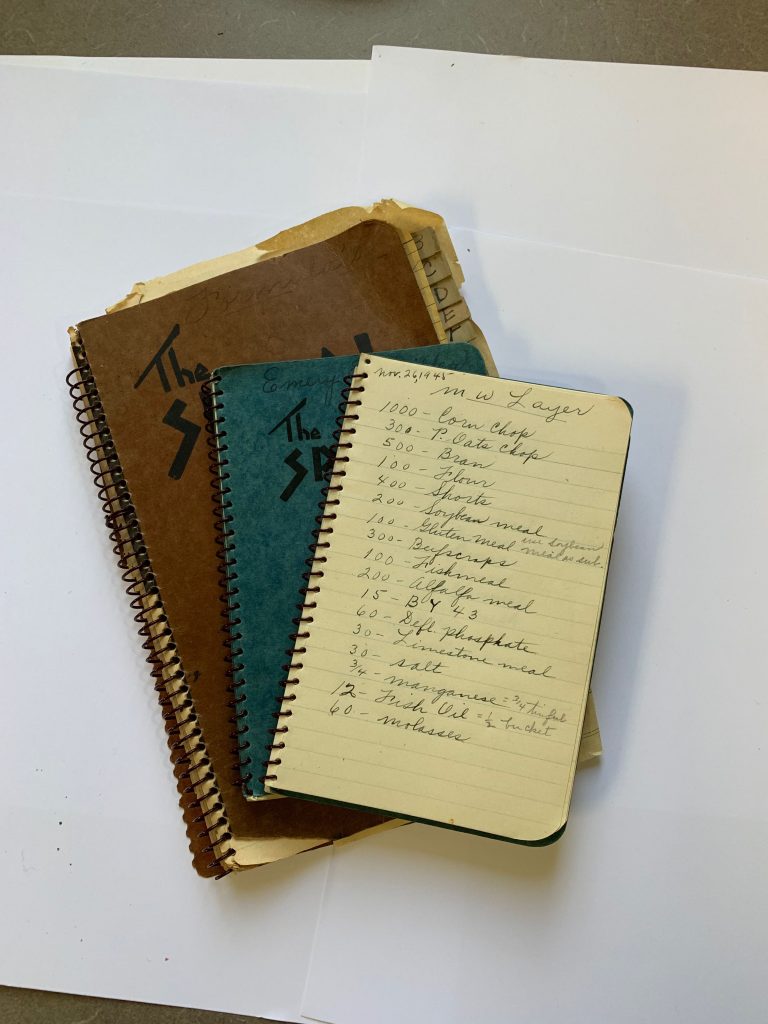 Hand written journals photographed for a company history book.